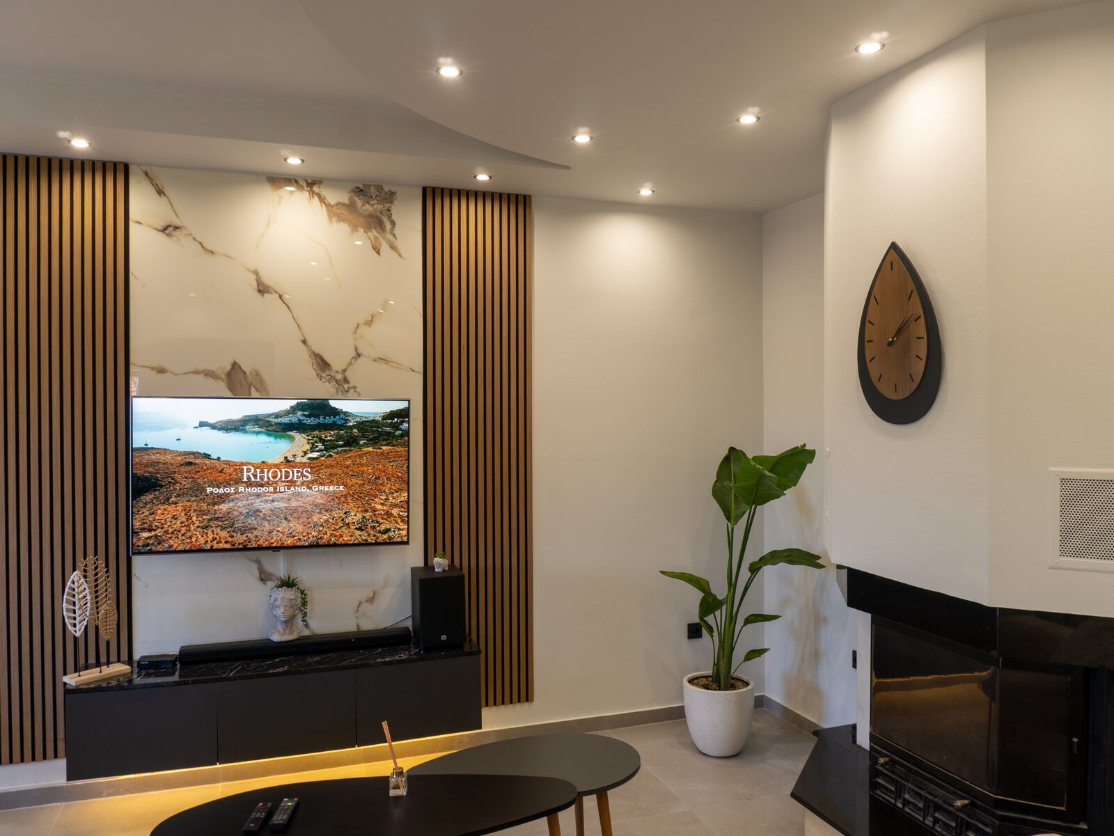 Casa Avgeri living room with TV wall and fireplace, Afandou Rhodes